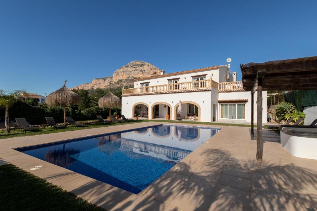 a house with a swimming pool in front of a house at Paulina in Jávea