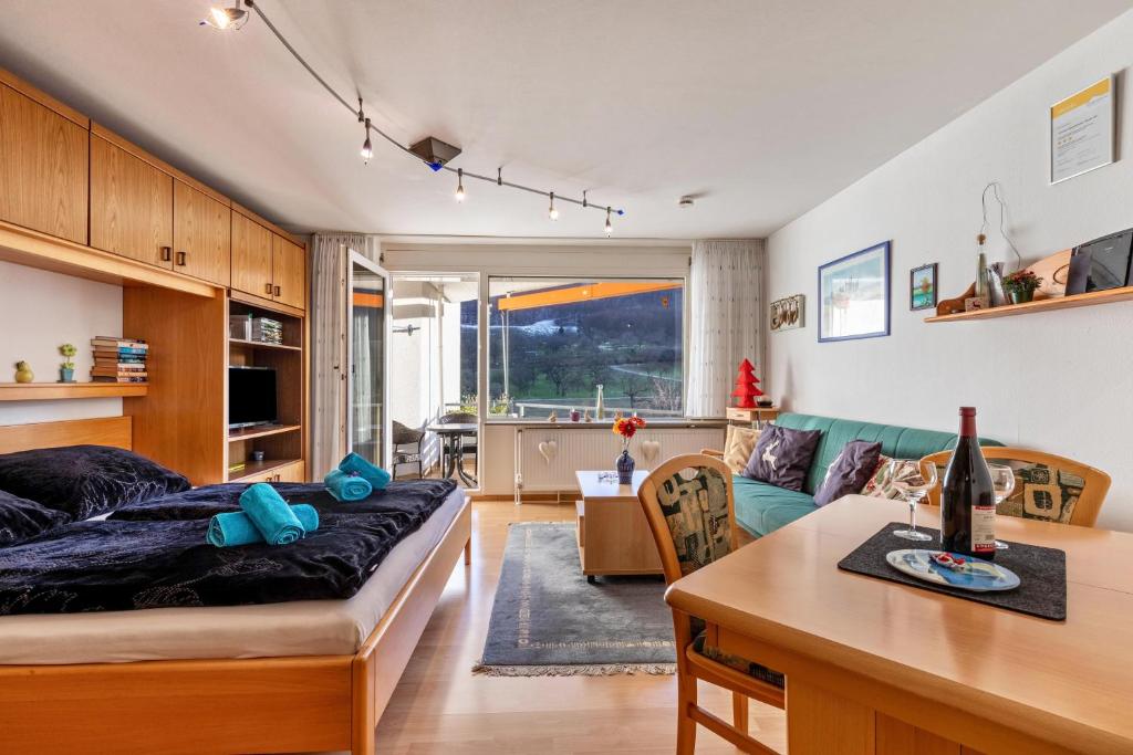 a living room with a bed and a table at Studti 134 in Beuren