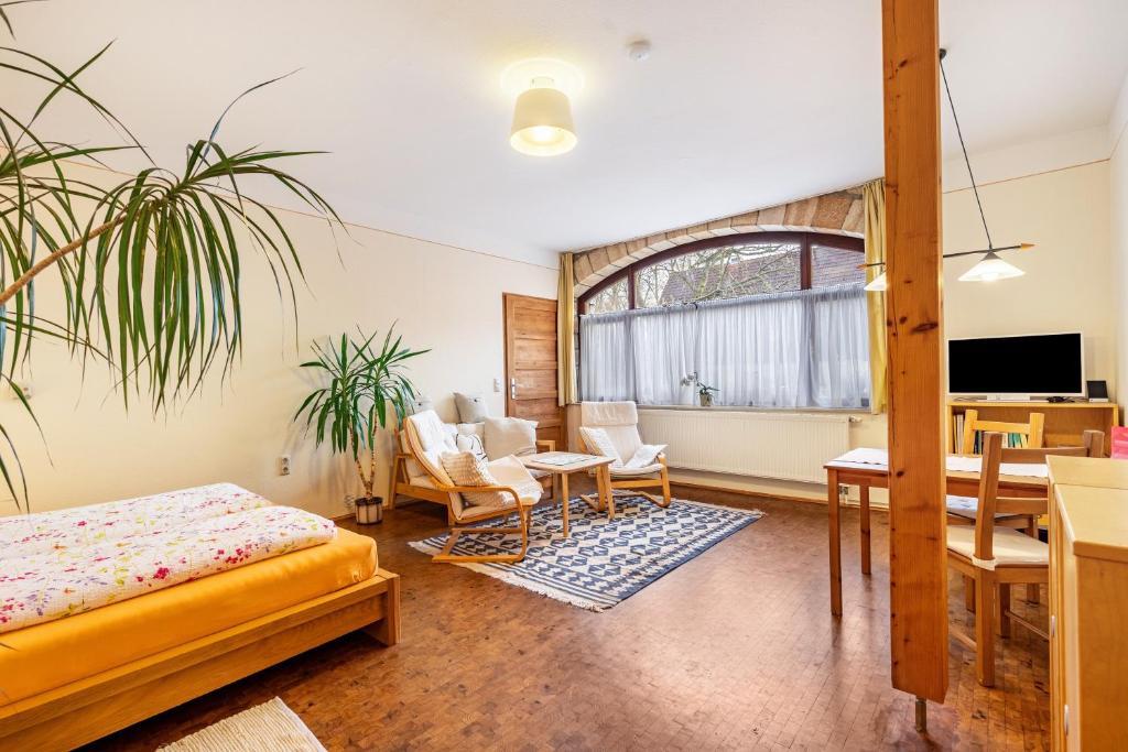 a bedroom with a bed and a table and chairs at Gemütliches Apartment In Lohmen in Lohmen