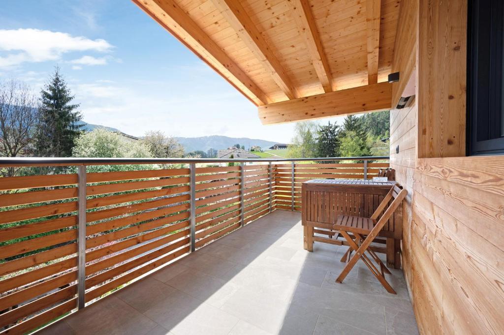 a balcony with a wooden fence and a wooden table at Haus Mader 1 in Riscone