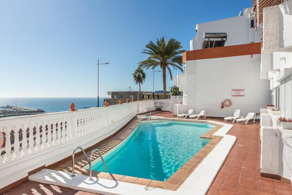a swimming pool with a view of the ocean at Sweet Home in Puerto Rico de Gran Canaria