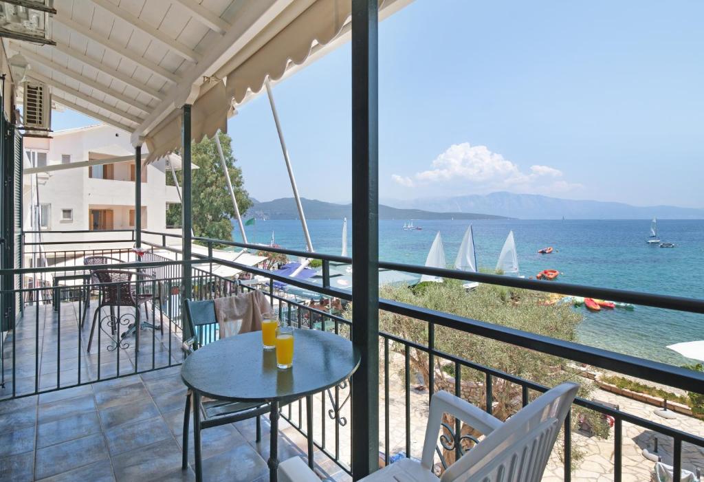 a balcony with a view of the ocean and sailboats at S8 room in Nikiana