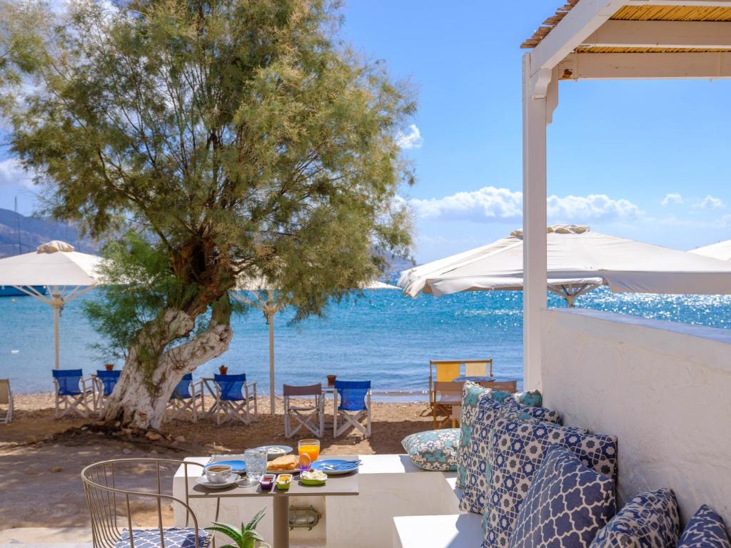 a patio with a table and a view of the ocean at Echinousa Kimolos katoikia no5 in Kimolos