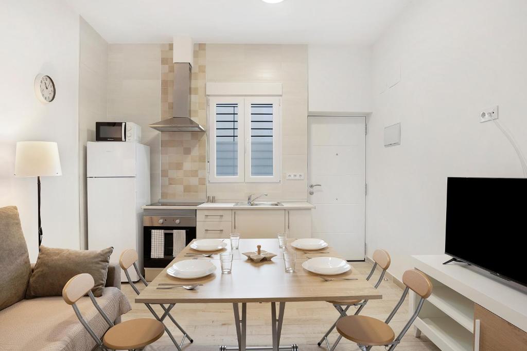 a kitchen with a table and chairs in a living room at Apartamento Guzmán A in Barbate