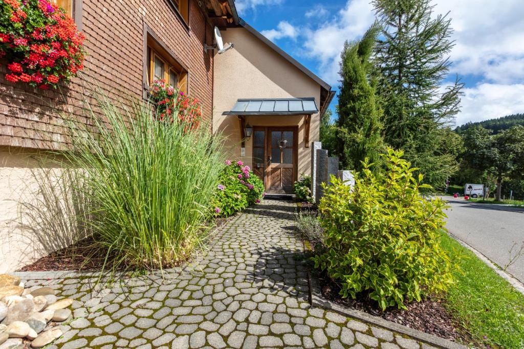a house with a stone walkway in front of a building at Connerhof Todtnauberg in Todtnau
