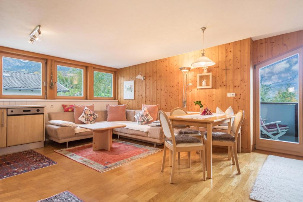 a living room with a couch and a table at Försterhaus Wohnung Dachgeschoss in Egg