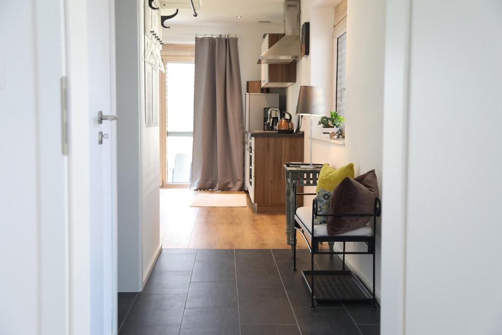 a hallway with a chair and a table at Appartement Burgblick in Harburg