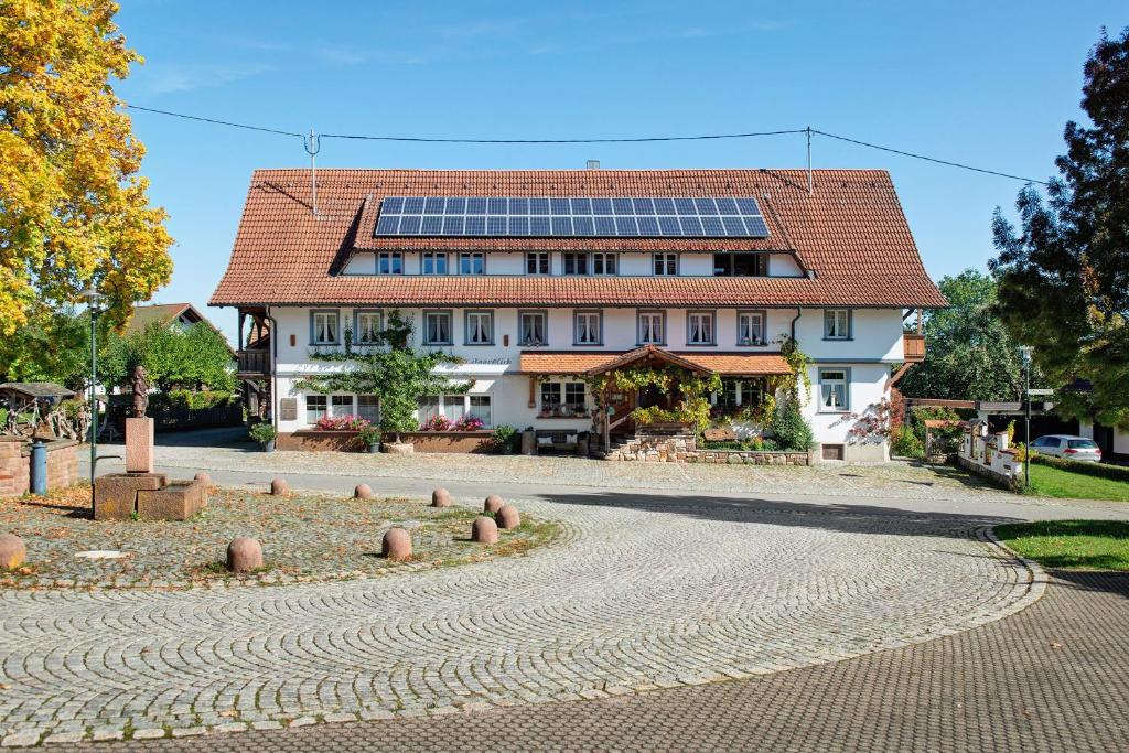 a building with solar panels on its roof at Pension Ferienwohnung Baarblick in Donaueschingen