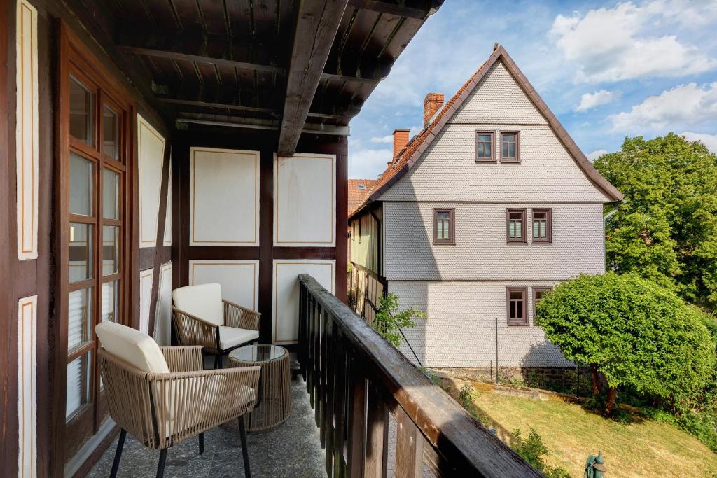 a balcony with two chairs and a house at You R Welcome in Lauterbach