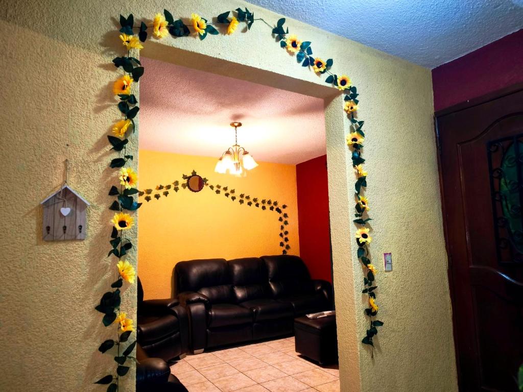 a living room with a door with sunflower decorations at Casa Mary's in Quetzaltenango