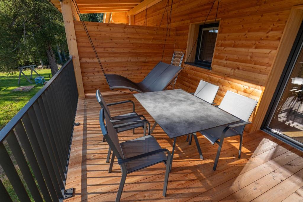 a patio with a table and chairs on a deck at Ferienwohnung Mittager Edelweiss in Avelengo