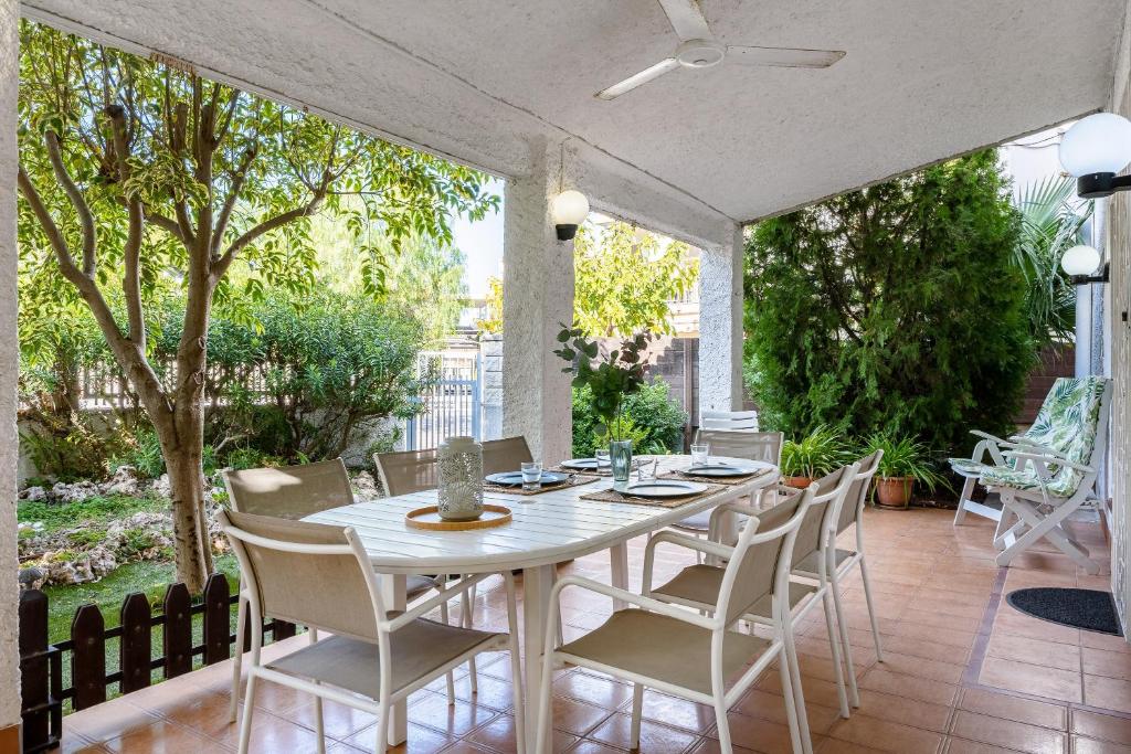 a white table and chairs on a patio at Villa 30 m from the beach Cambrils in Cambrils