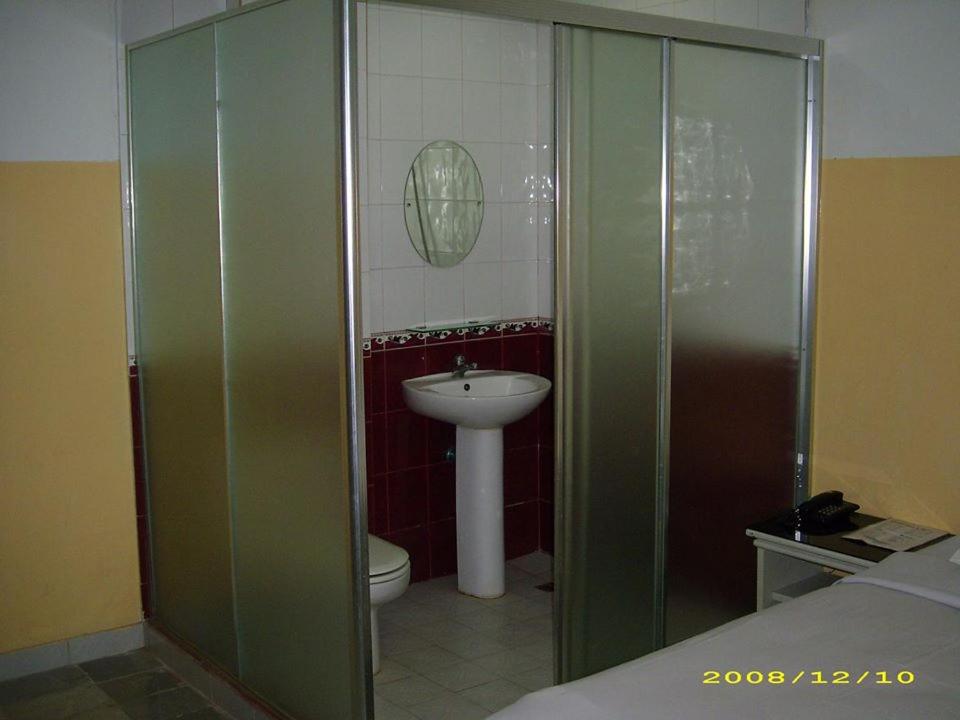 a bathroom with a sink and a toilet at Hotel Pinangsia in Jakarta
