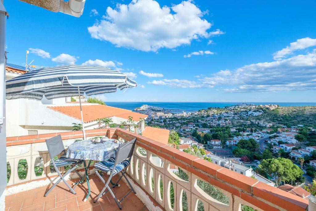 a balcony with a table and chairs and an umbrella at Maison Mer Peniscola in Peniscola