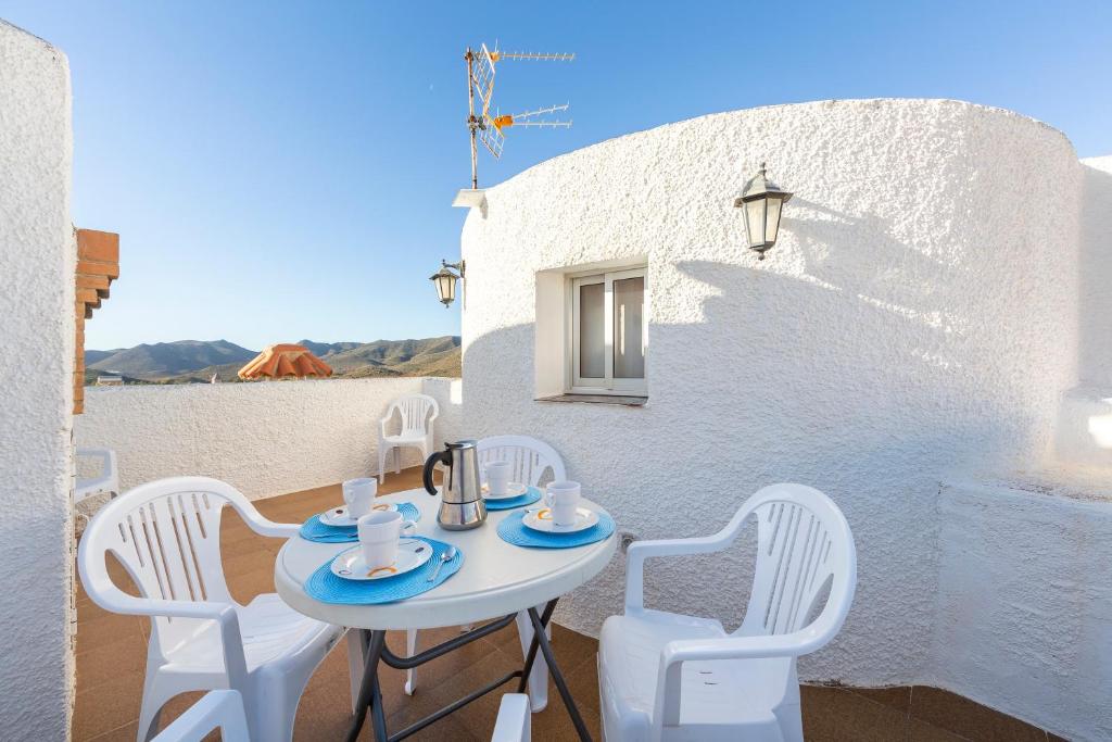 a white table and chairs on a balcony at Villa Loli 2 in El Pozo de los Frailes