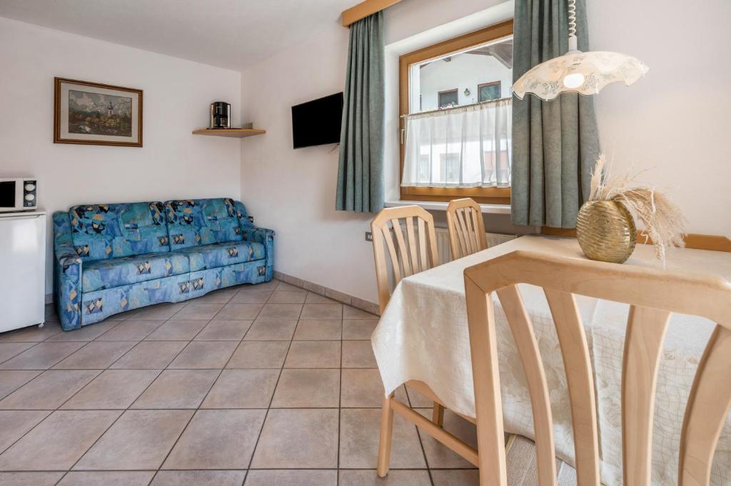 a living room with a table and a couch at App Sonne Nr 18 in Lutago