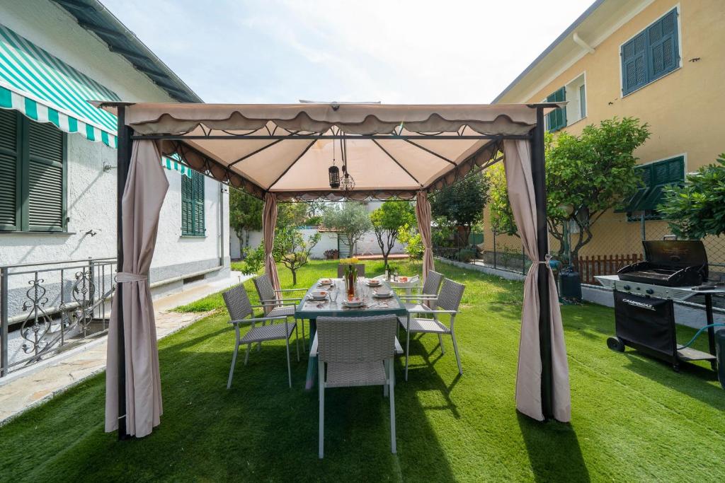 a gazebo with a table and chairs on a lawn at Villa Verde - 300m From Sea in Bordighera