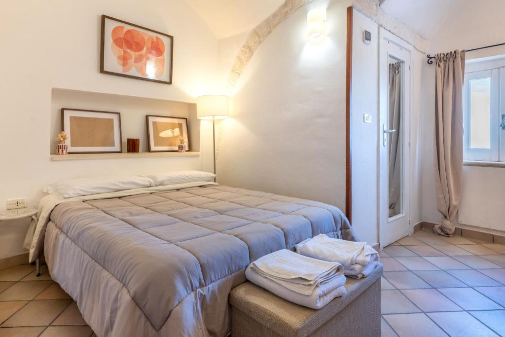 a bedroom with a large bed in a room at Dimora La Piana in Ostuni