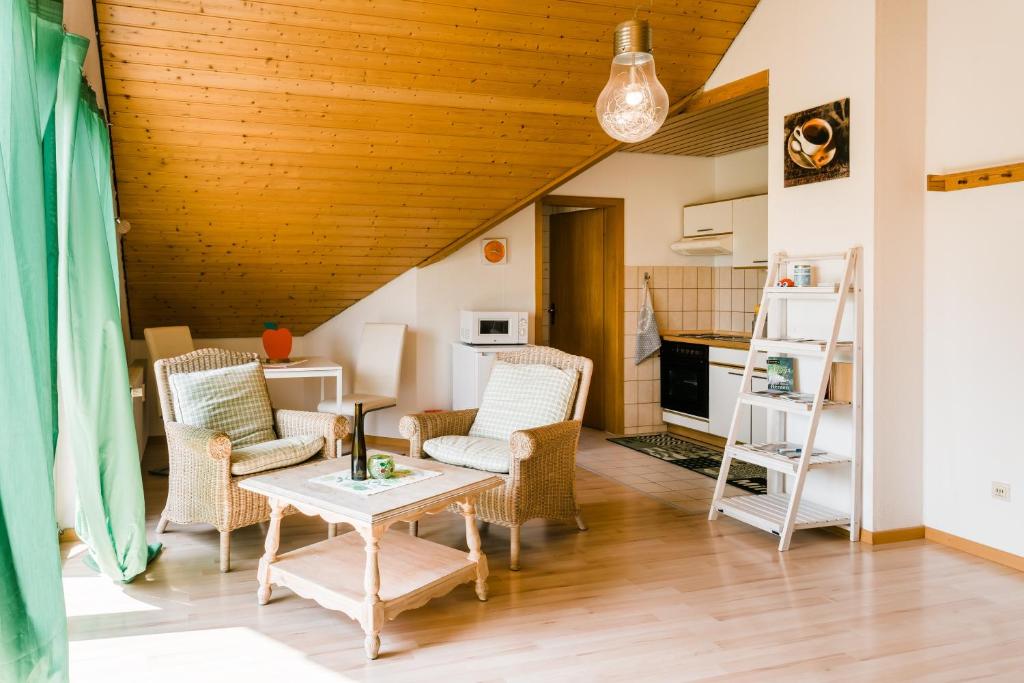 a living room with a table and chairs at Jonagold in Stockach