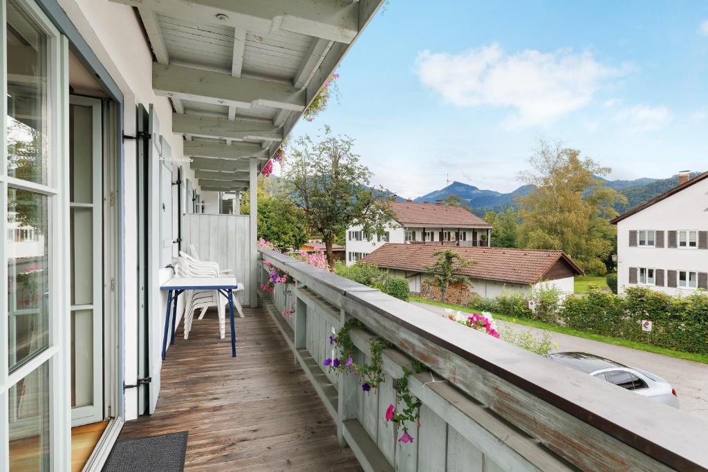 a balcony with a table and a chair on it at Fewo Brünnstein - Nr 28 Pool, Sauna in Oberaudorf