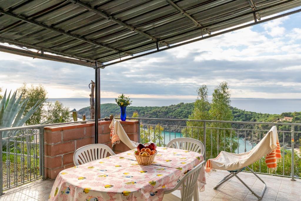 a table and chairs on a balcony with a view at Simona Panorama in Fetovaia