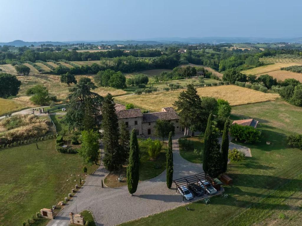 an aerial view of a mansion with cypress trees at Villa Arnolfo in Colle di Val d'Elsa