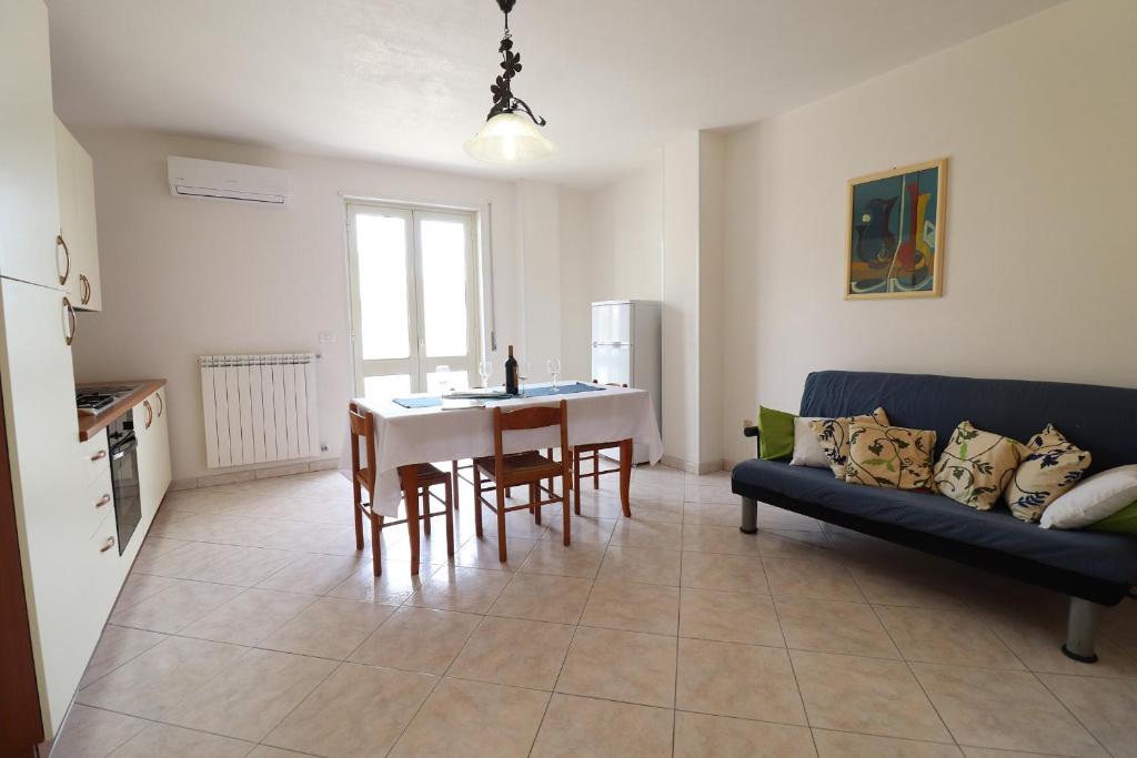 a living room with a table and a blue couch at Casa Vacanze Marta in Otranto