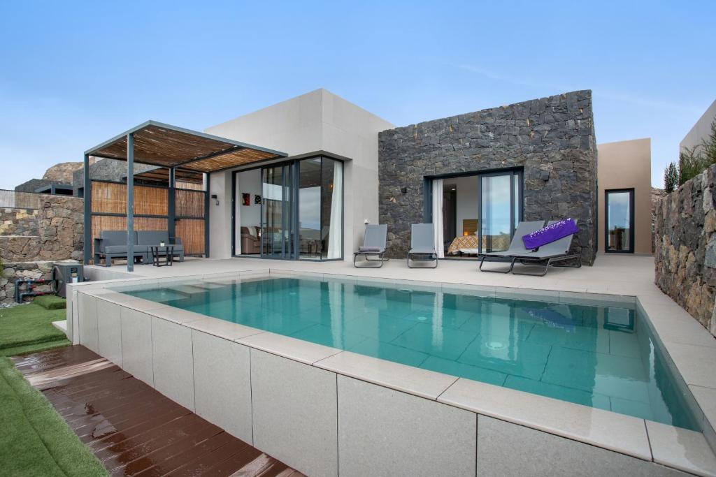 a swimming pool in the backyard of a house at Yucas Villa 13 in San Bartolomé