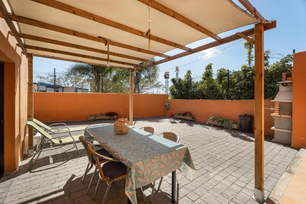 a patio with a table and chairs on a patio at Villa María in Taco
