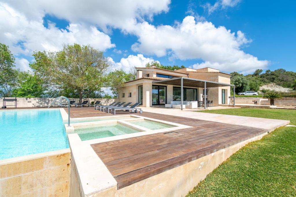 a home with a swimming pool and a house at Dalt Son Morro in Santa Margalida