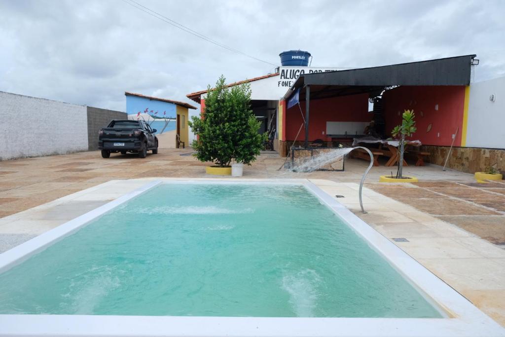 a swimming pool in front of a building at Refúgio Paraíso in Santo Amaro