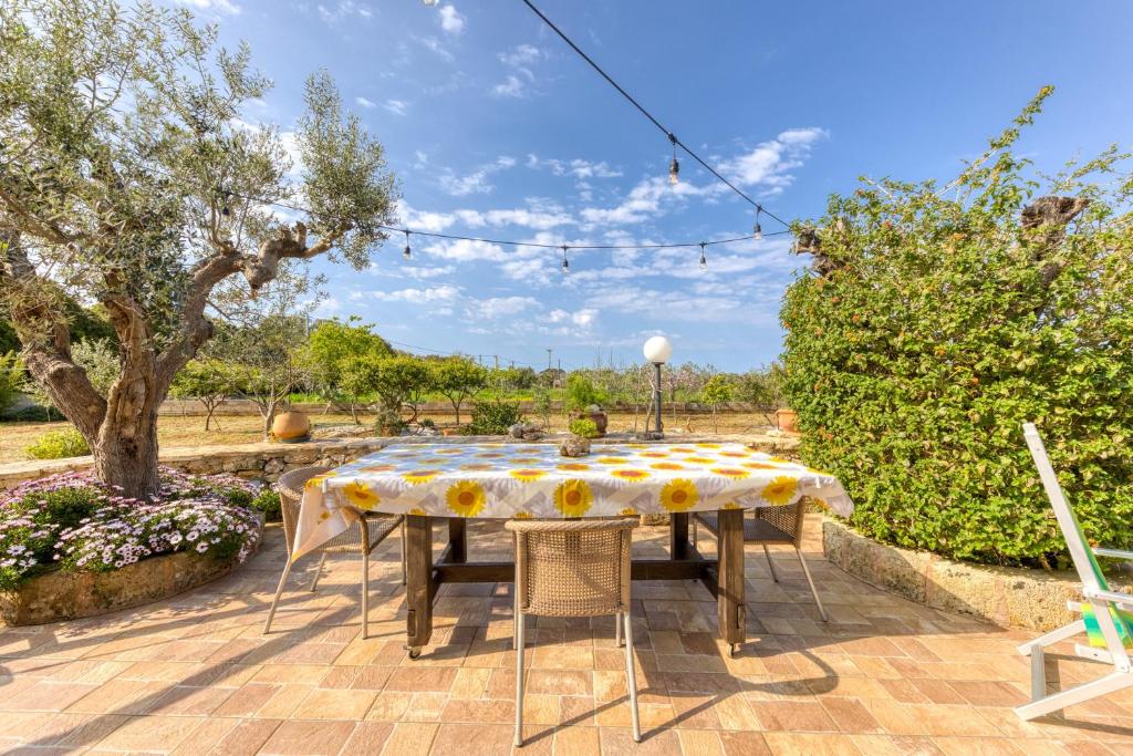a table with a yellow and white table cloth at Villetta La Pajara in Morciano di Leuca