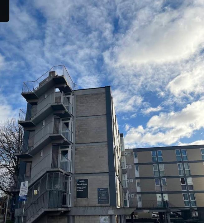 a tall building with a balcony on the side of it at Abez Accs in Portsmouth