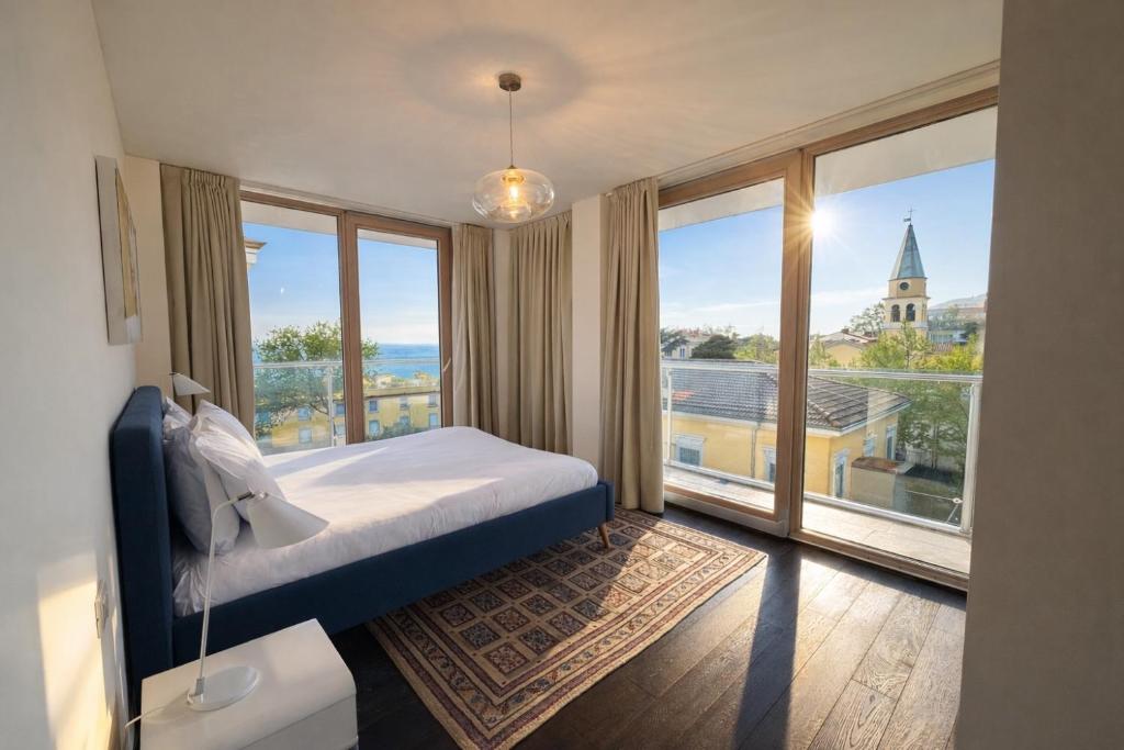a bedroom with a bed and a large window at Panorama Apartment in Trieste
