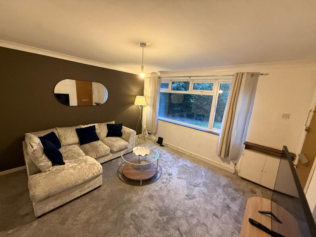 a living room with a couch and a table at fir tree in Southampton