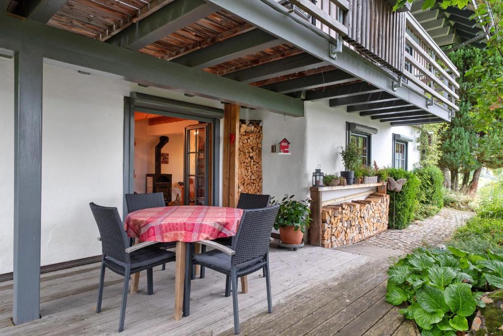 a patio with a table and chairs on a deck at Ferienwohnung Besamia in Todtnau