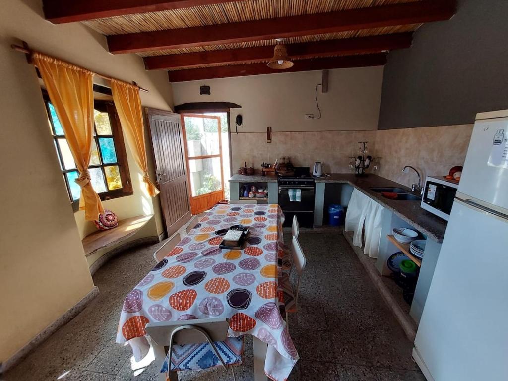 a kitchen with a table in the middle of a room at Casa Manipa -3 dormitorios in Cafayate