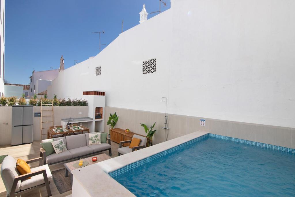 a swimming pool in the middle of a living room at The Olive Tree Apartment in Tavira