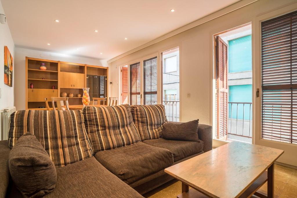 a living room with a couch and a table at Canet Beach 1 in Canet de Mar