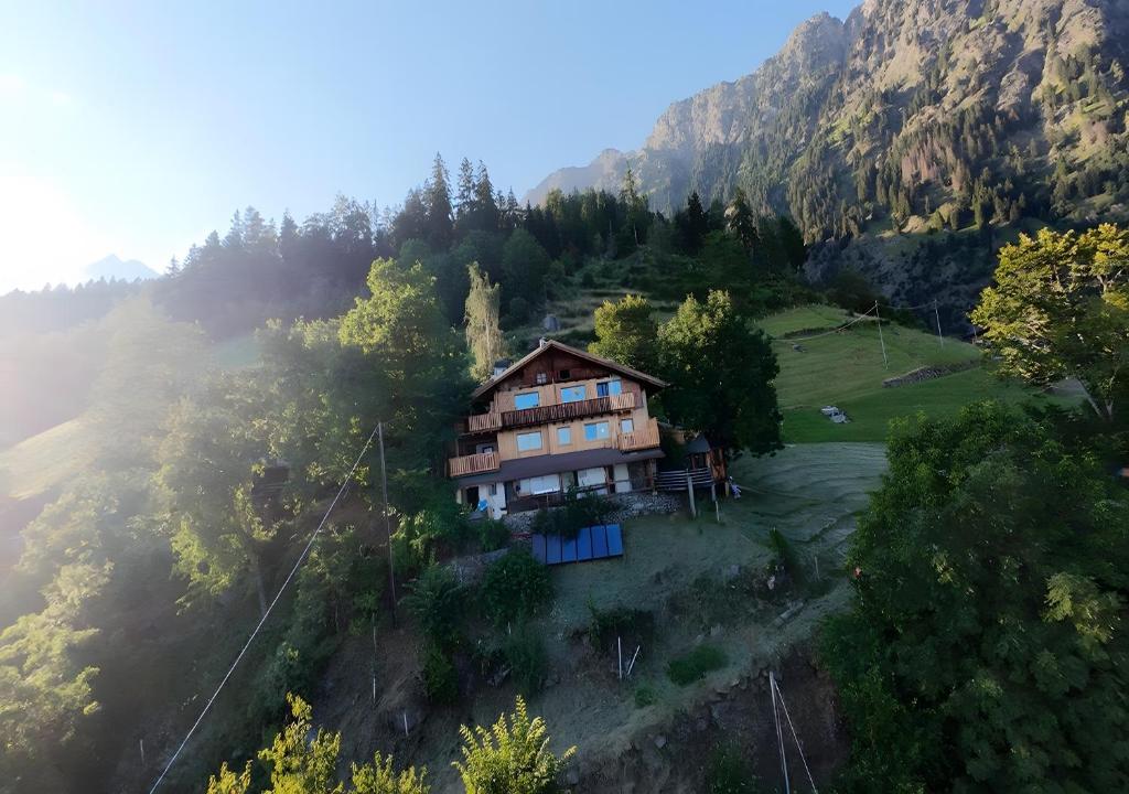 a house on a hill in the middle of a mountain at Hauserhof in Lagundo
