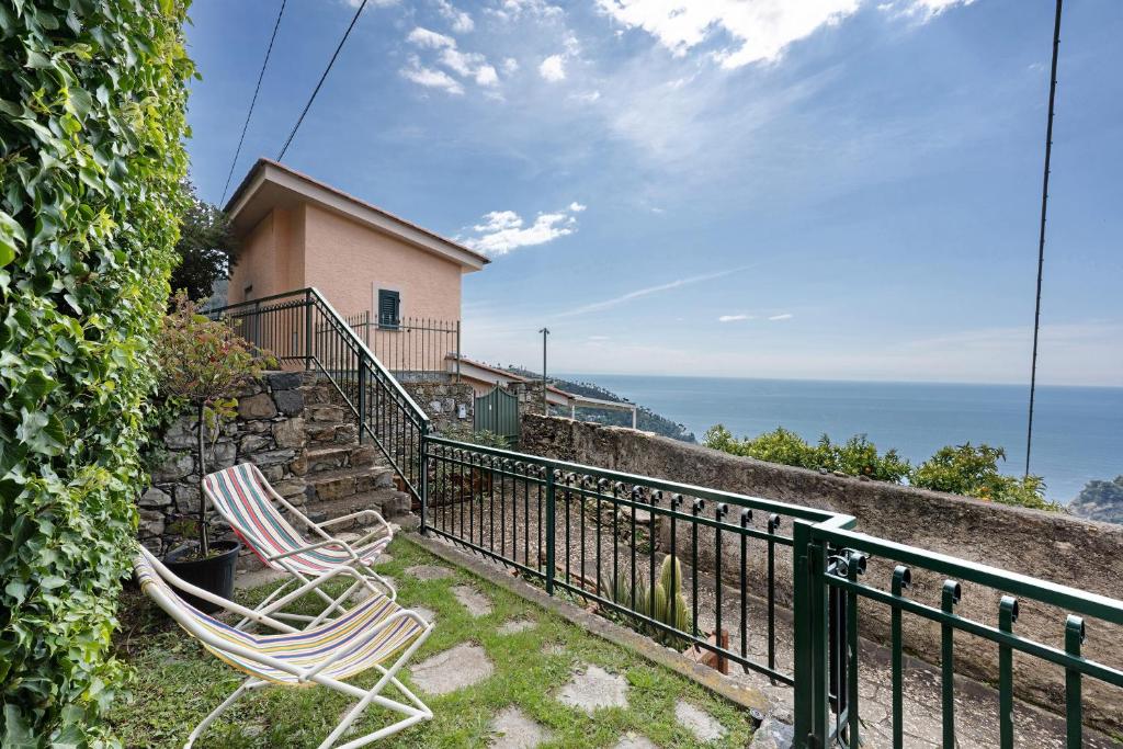 two chairs sitting on a balcony with the ocean at Bilo Costella in Bonassola