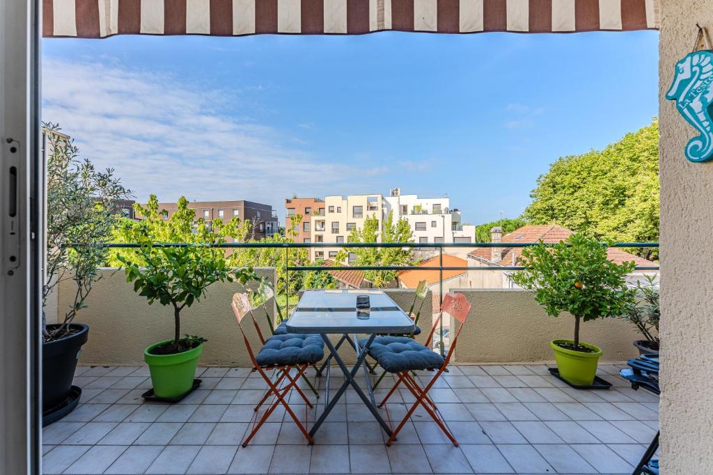 a patio with a table and chairs on a balcony at Petitbuch in La Teste-de-Buch