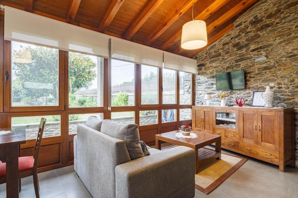 a living room with a couch and a table at Camiño in Ordes