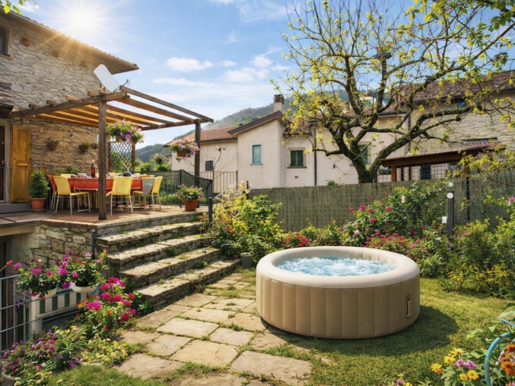 a garden with a hot tub in the yard at Apartment Torre by Interhome in Palazzuolo sul Senio