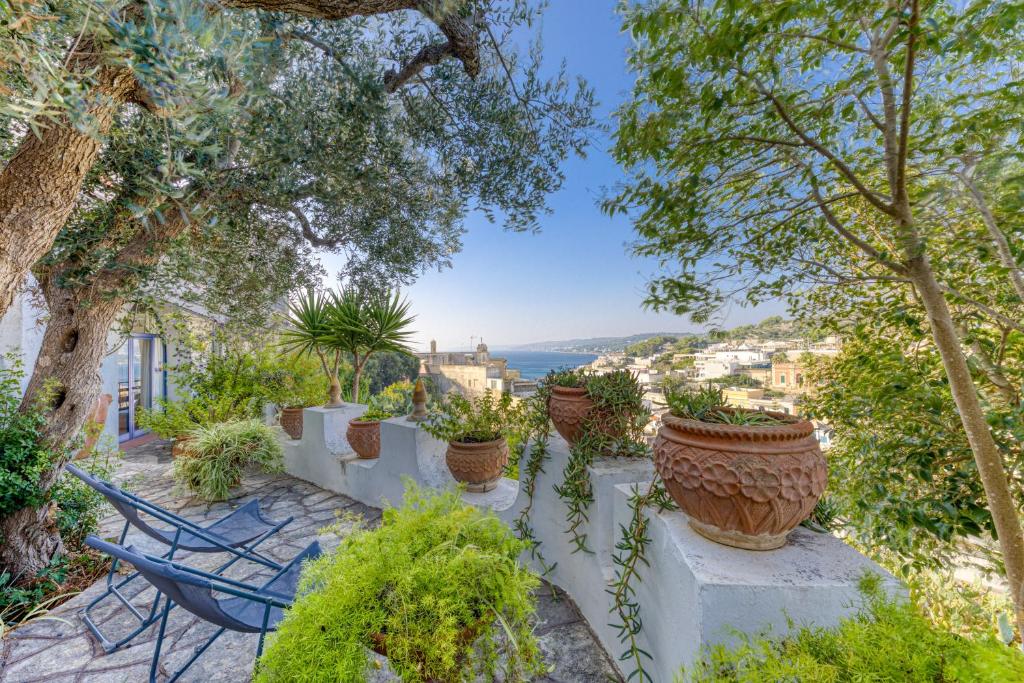 a patio with a chair and potted plants at Villa Blu La Cambusa in Castro di Lecce