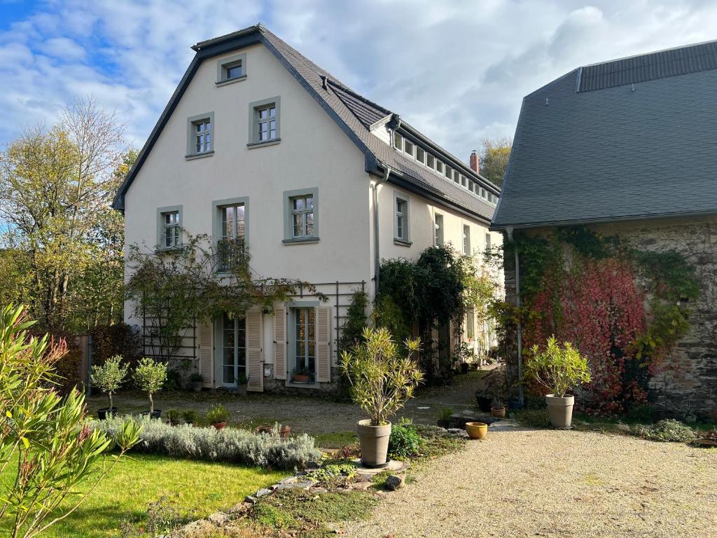 a white house with a black roof at Vorwerk Biensdorf in Lichtenau