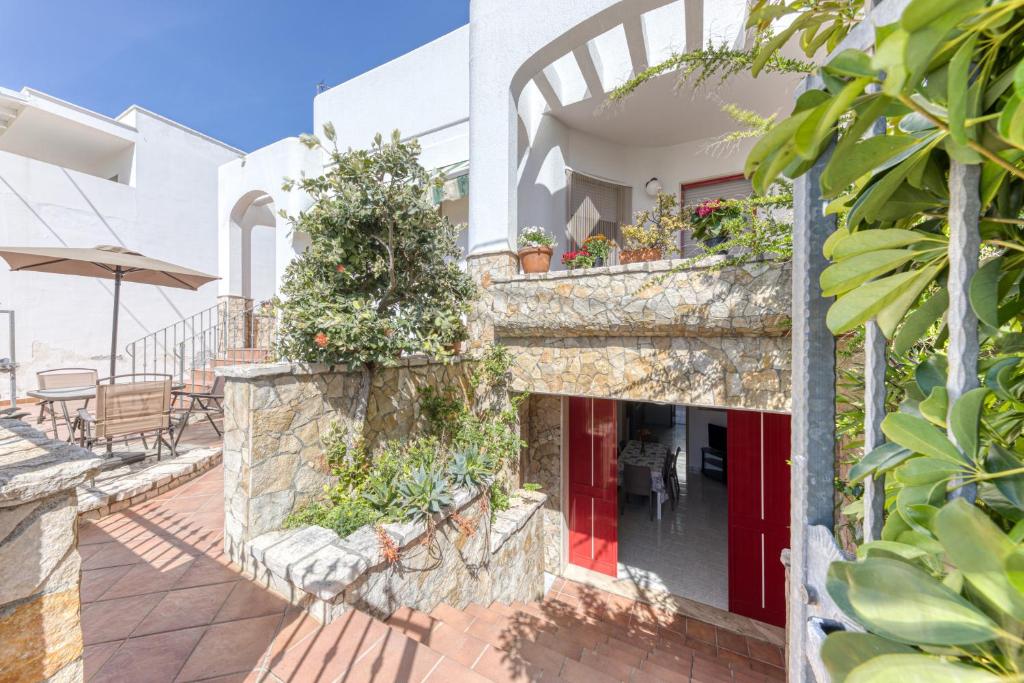 an external view of a house with a red door at Pilella in Alliste