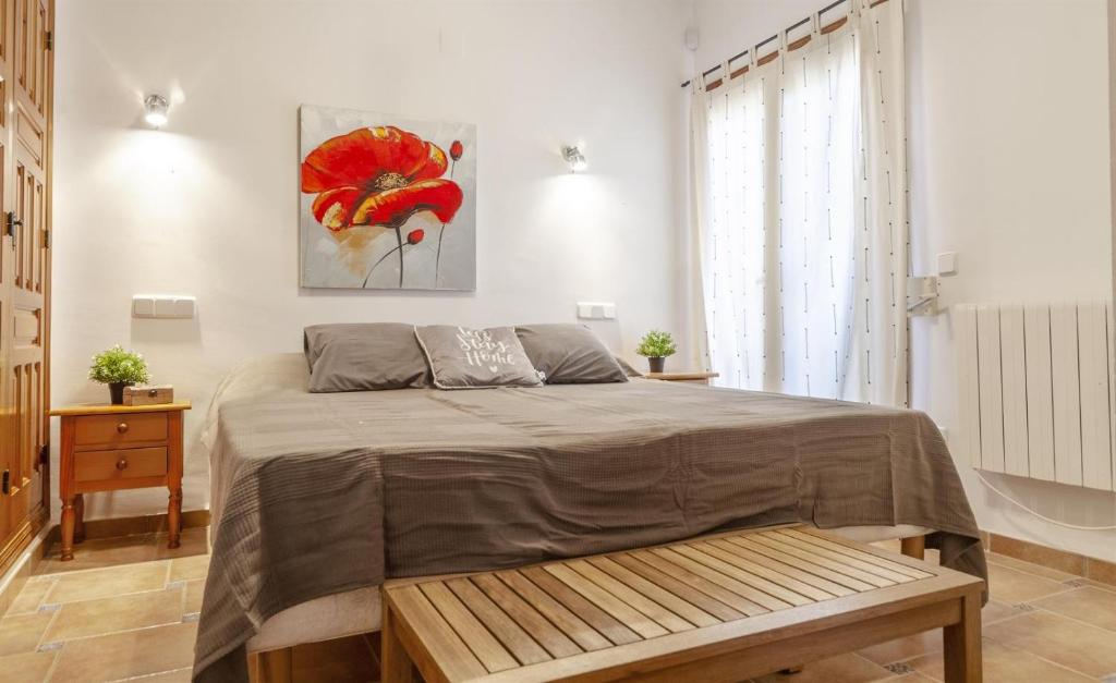 a bedroom with a bed and a painting on the wall at Vistas a Moraira in Teulada
