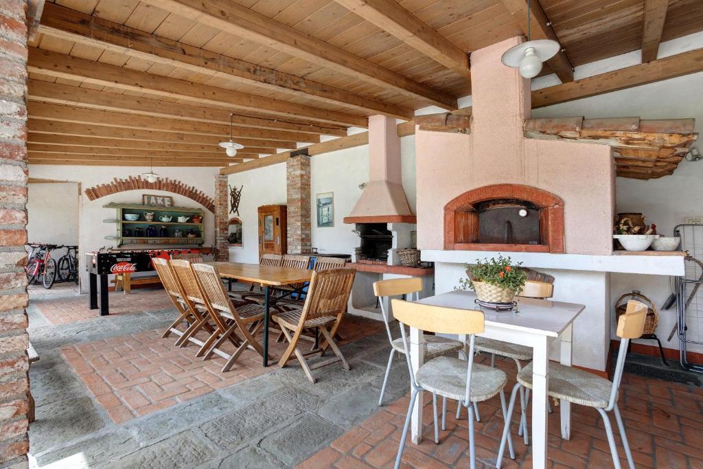 a kitchen and dining room with a table and a fireplace at La Vigna - Tra 5 terre e Versilia in Sarzana