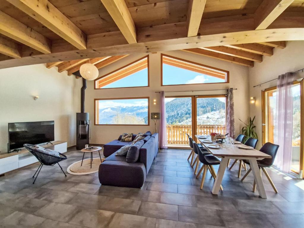 a living room with a blue couch and a table at Chalet Alpina by Interhome in Ovronnaz